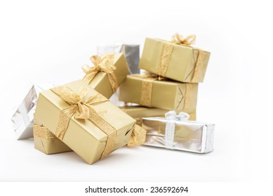 Beautiful Gifts In Gold And Silver Packaging For Christmas, Holidays, Isolated On White Background. Sparkling Ribbon With Glitter On Presents