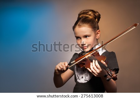 Beautiful girl alone playing on the violin