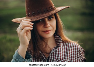 Beautiful Girl In American Texan Style. Portrait Of A Girl In A Field