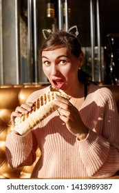 Beautiful Girl With An Appetite Eating A Burrito In The Cafe