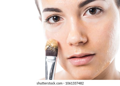 Beautiful Girl Applying Honey Mask On Face With Brush Isolated On White