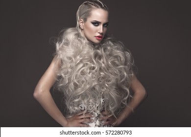 Beautiful girl in art dress with avant-garde hairstyles. Beauty the face. Photos shot in the studio. - Shutterstock ID 572280793