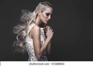 Beautiful girl in art dress with avant-garde hairstyles. Beauty the face. Photos shot in the studio. - Shutterstock ID 572280823
