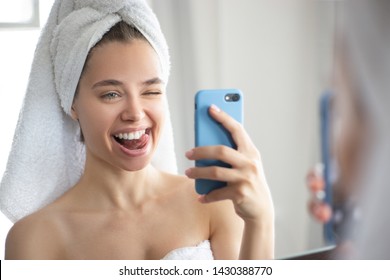 Beautiful Girl In The Bathroom Takes A Selfie In The Mirror And Grimaces