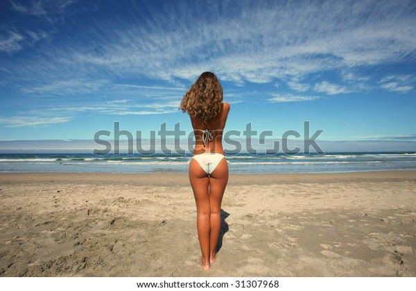 Candid Latinas laying on the beach