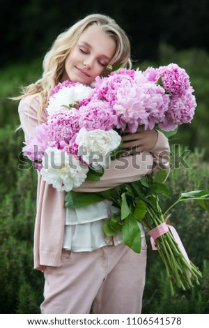 Similar – Woman makes festive bouquet with vase