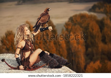 Beautiful girl with bird on mountain