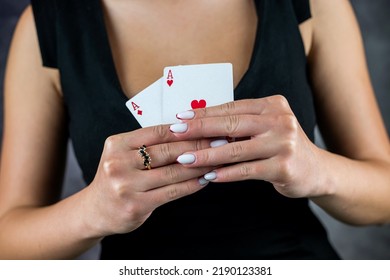 Beautiful Girl In Black Dress Holds Ace Of Poker Cards Near Sexy Cleavage. Woman In Poker