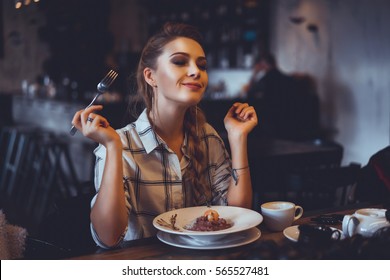 beautiful girl blonde hair and make-up, dine in the restaurant, eating delicious served hot dish, Italian pasta, spices, fine dining, europe, food, Kef, lunch, breakfast and dinner in the cafe - Shutterstock ID 565527481