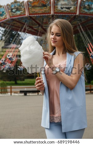 Beautiful girl blonde posing in the amusement Park