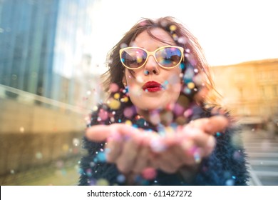 Beautiful Girl Blowing Confetti In The Street