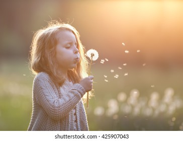 Beautiful Girl Blowing Dandelion