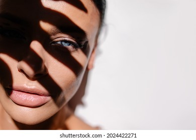 Beautiful Girl With Blue Eyes Portrait. Sunscreen Concept. Suntan Cream. Tanned Skin. Sensual Hot Sexy Young Woman Close-up. White Background Banner Copy Space Hard Shadow Trend. Spa Summer Vacation. 