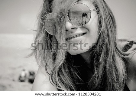 Similar – Image, Stock Photo Young woman at the stand blond hair blows around her