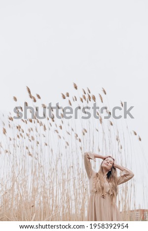 Similar – beautiful young woman siiting outdoors in forest, dreaming with closed eyes in serene pose