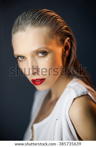 a beautiful girl, brunette with big blue eyes, in the studio, hot and cold light, a closer look boring .slicked hair. dirty hair