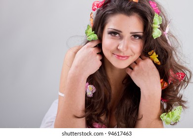 Beautiful girl with butterflies in hair poses in studio isolated on white - Shutterstock ID 94617463