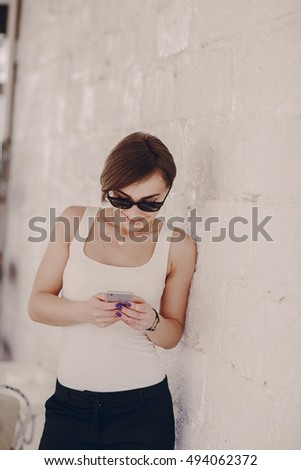 Similar – Woman with earphones listening music in smartphone