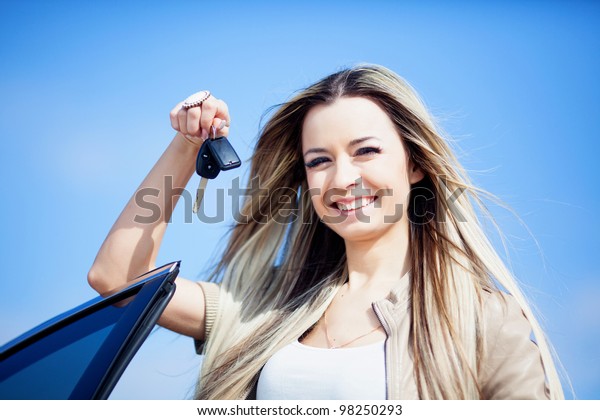 Beautiful girl with car key in\
hand