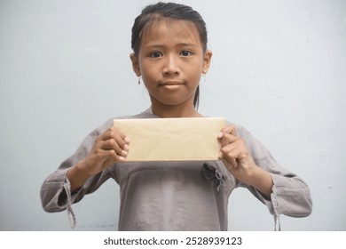 Beautiful girl child stretching blank paper - Powered by Shutterstock