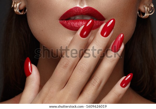 Beautiful\
girl with a classic make up and multi-colored nails. Manicure\
design. Beauty face. Photo taken in the\
studio