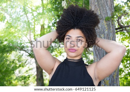 beautiful girl curly with hand in her hair