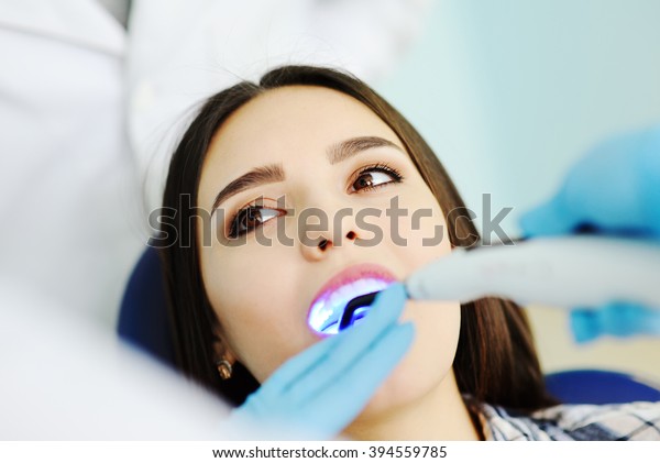 beautiful girl at\
the dentist. Dental\
fillings