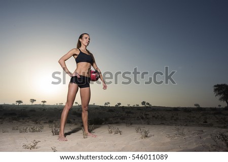 beautiful girl in desert at sunrise holding a ball