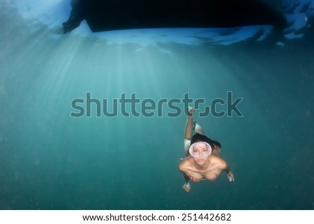 beautiful girl diving in the deep blue sea 