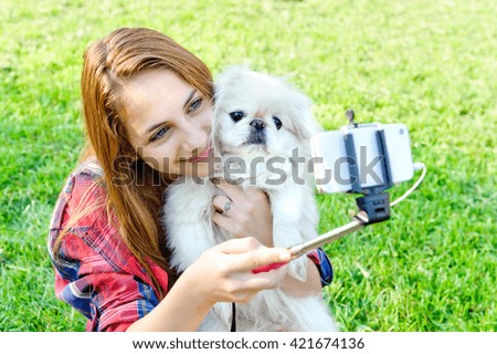 Beautiful girl with dog taken pictures of her self,