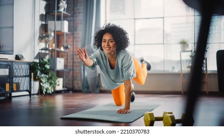 Beautiful Girl Doing Fitness At Home, Stretching Her Legs During The Morning. Authentic Woman Doing Workout, Yoga Exercises On Mat. Healthy Fit Confident Female Staying Healthy.