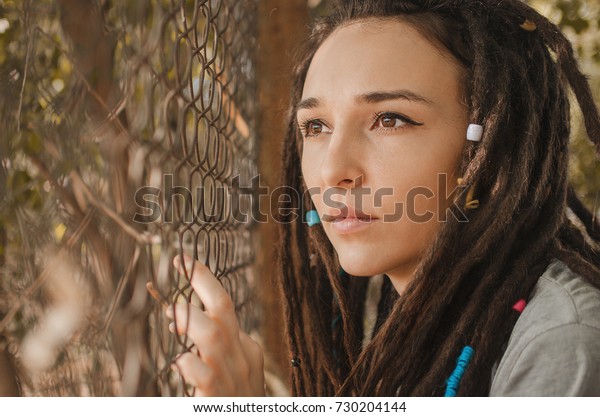 Beautiful Girl Dreadlocks Behind Iron Fence Stock Image