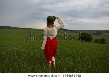 beautiful girl in dress and hat on nature