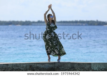 beautiful girl in dress on a tropical sea resort
