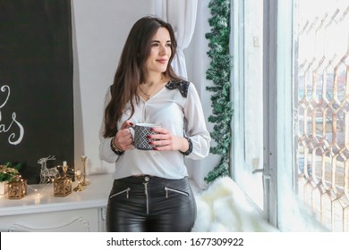 Beautiful girl drinking coffee at Christmas
