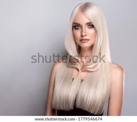 Beautiful girl with dyed  long hair in blond. Stylish hairstyle  done in a beauty salon. Beauty, cosmetics and makeup