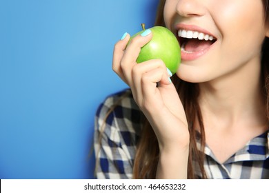 Beautiful girl eating apple, closeup