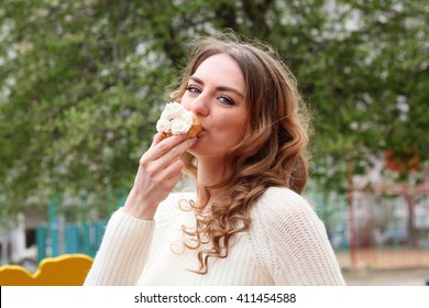 Beautiful Girl Eating A Delicious Cake With Whipped Cream And Enjoy A Delicious Meal On The Street