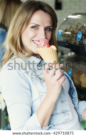 Beautiful girl eating an italian ice cream, selective focus