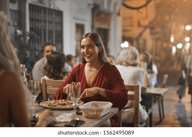 beautiful girl eats pizza at outdoor restaurant