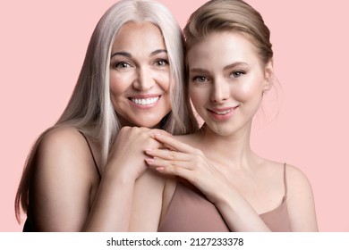 Beautiful girl with elderly mum hugging. Smiling mature gray-haired mother and young adult daughter cuddling. Happy family enjoying tender moment, female generations, 