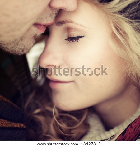 beautiful girl embraces the guy