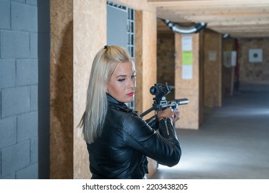 A Beautiful Girl Is Engaged In Tactical Shooting At A Shooting Range.