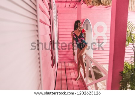 Similar – Young surfer woman with top and bikini kissing surfboard