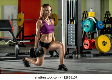 beautiful girl, execute exercise with dumbbells, in dark gym - Shutterstock ID 412956109