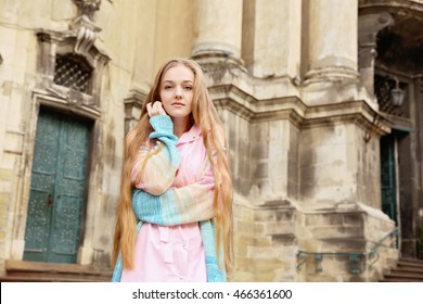 Beautiful Girl With Extra Long Blond Hair In Soft Pink Dress Walking The Streets Of The City. Romantic Woman Portrait. Summer Street Fashion Look