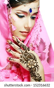 Beautiful Girl Face With Perfect Arabian Make Up With Hand With Detail Of Henna Being Applied To It Isolated