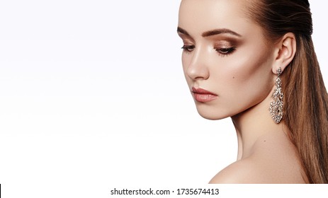 Beautiful Girl in Fashion Earrings with Luxury Makeup and Hairstyle. Attractive Model. Glamour Portrait with Copy Space. Young Woman wearing Chic Accessories - Shutterstock ID 1735674413