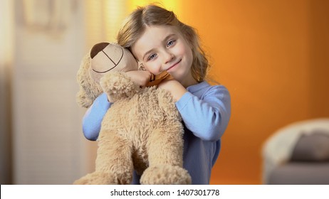 Beautiful Girl With Favourite Teddy Bear Toy Smiling At Camera, Happy Childhood