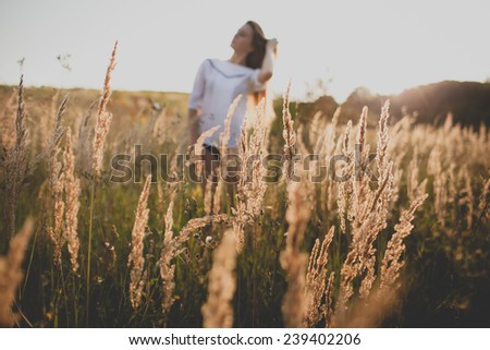 Image, Stock Photo Young woman looking at the sunset.